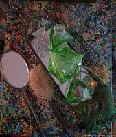 Entire lot showing mirror, brush, tray, perfume bottles and atomizer on splatter background