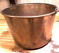 Full view of brass bucket showing overall form and handle