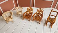 Five miniature chairs displayed on table