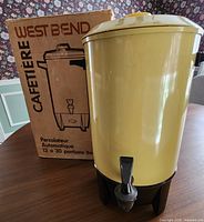 Full view of yellow West Bend coffee urn beside original box