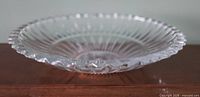Full view of clear cut crystal bowl on wood surface