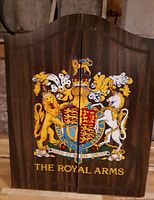 Closed wood cabinet showing Royal Arms crest
