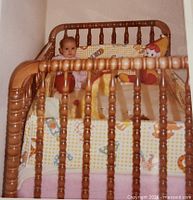 Vintage maple crib assembled with baby inside