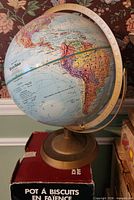Full view of globe on brass-tone base