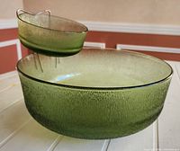 Large and small green glass bowls assembled with metal holder