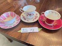 All three teacup and saucer sets on table