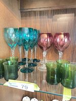 All three sets of coloured glasses on shelf