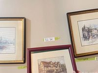 Three framed prints on wall: two London scenes, one English dwelling