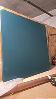Front view of teal square tabletop