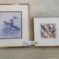 Both framed prints side by side on carpet