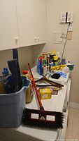 Overview of cleaners, tools and push broom on laundry machine