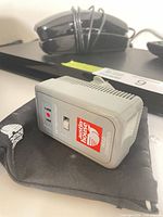 Sony Blu-ray player with phone, remote and converter visible