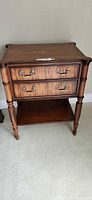 Front view of Ethan Allen nightstand showing drawers and shelf