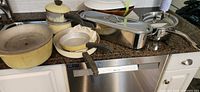 Group of cookware on countertop showing Club pots, skillets, stainless fish cooker and pot