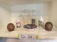 All shakers, grinders and bowl on shelf