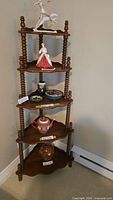 Full view of wooden five-tier shelf with contents shown for scale