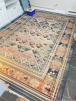 Full view of patterned wool rug on floor showing colors and design