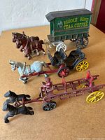 All three cast iron horse-drawn wagons grouped together
