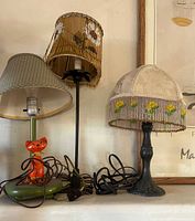 Front view of all three table lamps grouped together showing bases, shades and cords