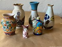 Group shot of all six ceramic vases