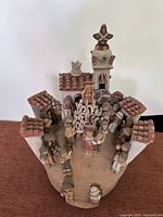 Angled front view showing entire terra cotta church scene with figures and architecture