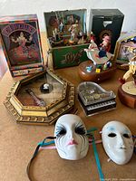Group shot showing all music boxes, glass piano and clown masks