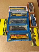 Stacked boxed HO scale trains from AHM, Tyco, Train Miniatures, Model Power