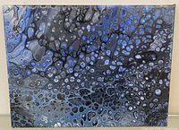 Front view of acrylic pour painting showing abstract cell pattern