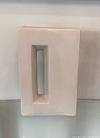 Front view showing rectangular form and central cutout