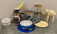 Full lot showing trinket box, pitcher, mug, tumblers, elephant figurine, teacup with saucer, dessert plate