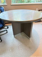 Full view of table showing top and pedestal base