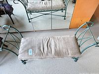top view of metal bench with beige cushion