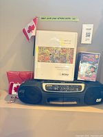 Boombox with cassette album and audiobook on top