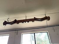 Front view of wooden yoke showing overall shape and wall mounting