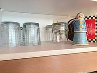 Grid pattern and starburst tumblers upside down on shelf