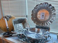 Group shot showing all metal serving pieces and wood board