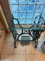 Full view of cast-iron base with glass top