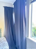 Two charcoal gray curtain panels hung on side-by-side windows