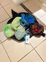 Group shot showing witch hat as base with wigs, mask and fez on top