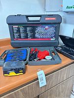 Overview showing Craftsman case, blue bit case, soldering iron, spool, punch set, small black/yellow bit box