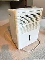 Front and side view of white Danby dehumidifier with power cord visible