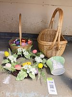 Group shot of both baskets, wreath, ceramic planter and eggs