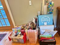 Full lot showing tote filled with bows, ribbons, gift bags and adjacent organizer with wrapping supplies