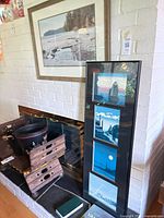 Framed beach landscape print displayed above fireplace