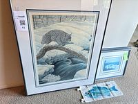 Overview showing large lynx print, smaller winter landscape print and fabric fish banner