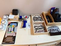 Overview of eyewear trays and household accessories on tabletop