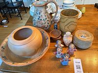 Group shot of all decorative pottery pieces, basket and figurines