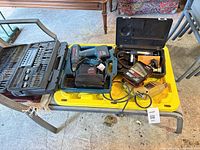 Overall lot with drills, bit case and inflator visible