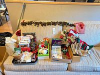 Entire lot arranged on sofa showing garland, stocking, trays and boxes of decorations