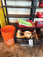 Stacked Home Depot 5-gal buckets beside crate with painting tools